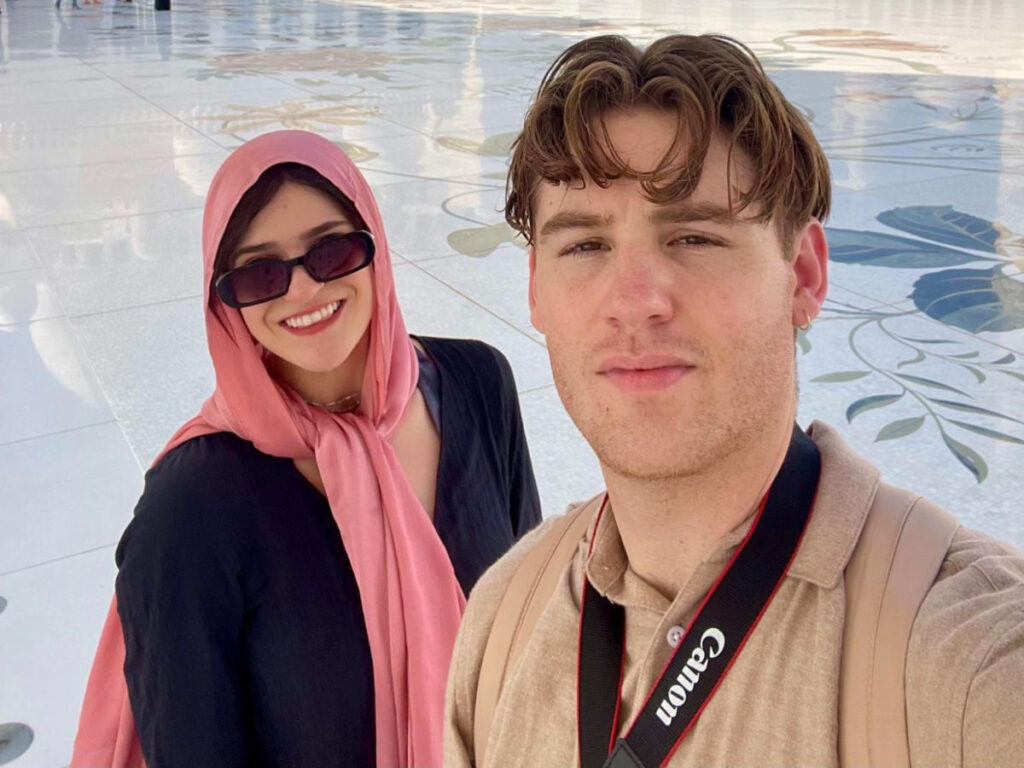 Travel Lemming author Betty wearing a pink headscarf together with her boyfriend in Sheikh Zayed Grand Mosque