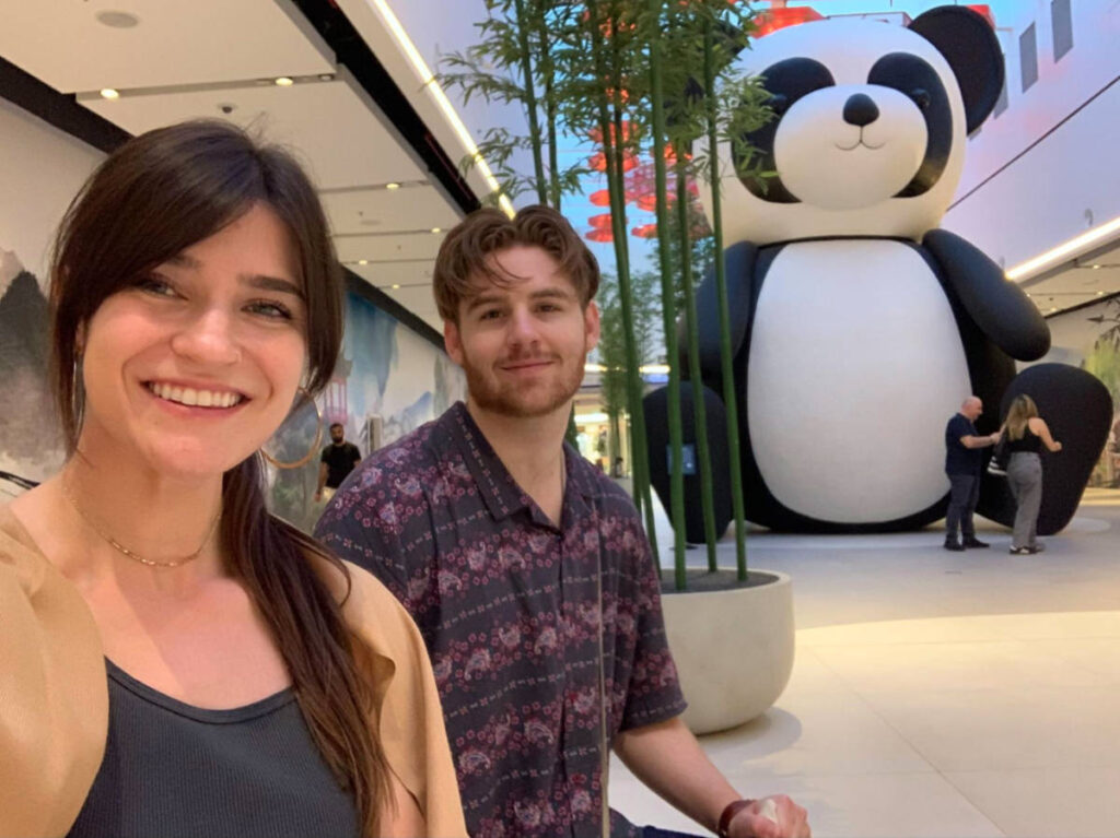 Author Betty and her boyfriend take a photo with the panda statue in China Town