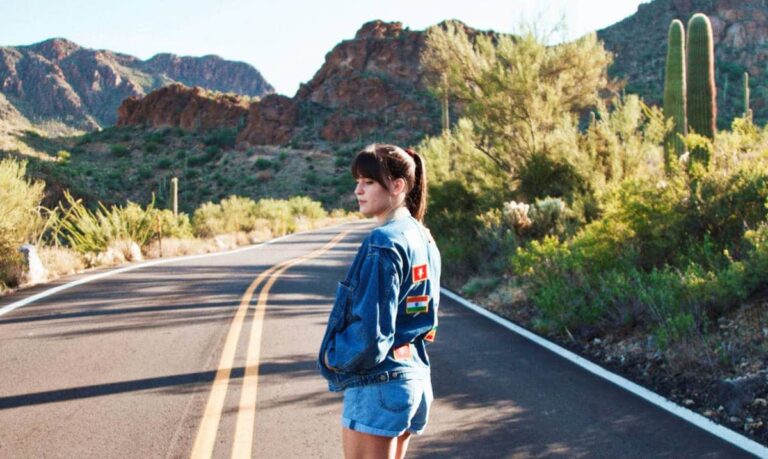 A woman in the middle of the road with the scenic view of the mountains in Tucson