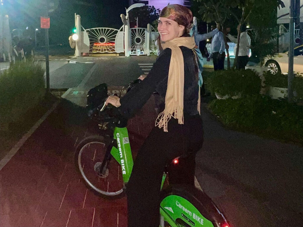 Author Betty riding a green Careem bike