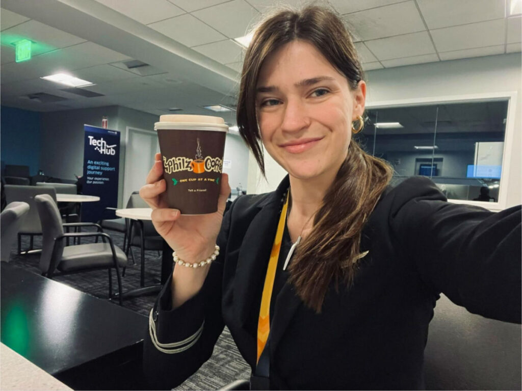 Author Betty smiling while holding cup of Philz Coffee