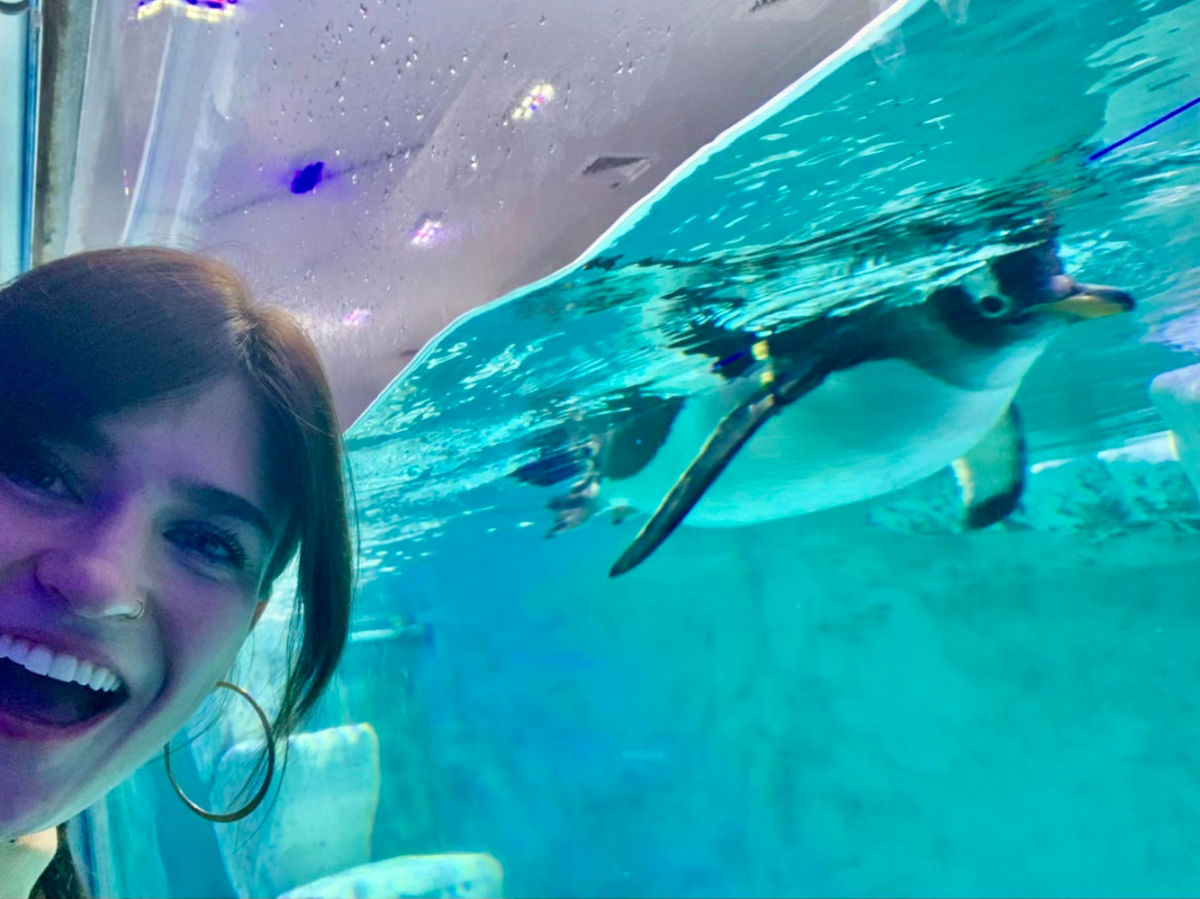 Author Betty excitedly taking a selfie with a penguin