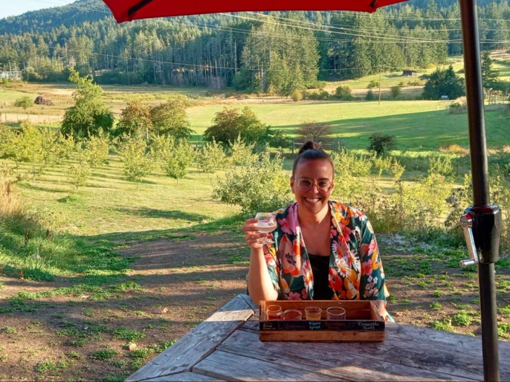 Author Catherine enjoying a drink on the patio at Salt Spring Wild Cider House