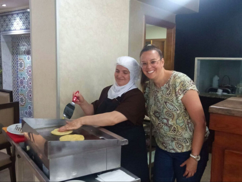 Author Catherine taking a photo with the woman preparing breakfast in Casablanca