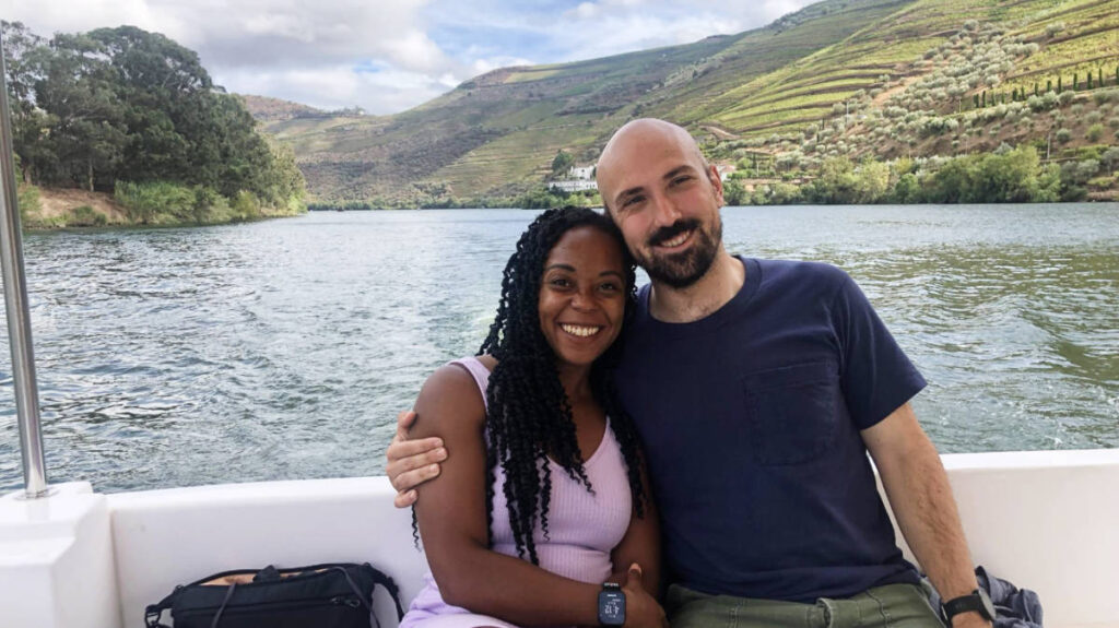 The author, Chelsea Booker with her husband on a boat tour in Portugal
