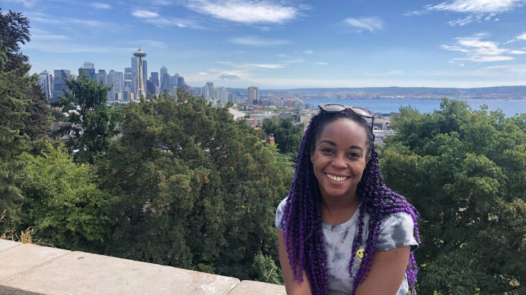 Author Chelsea smiling brightly at Kerry Park