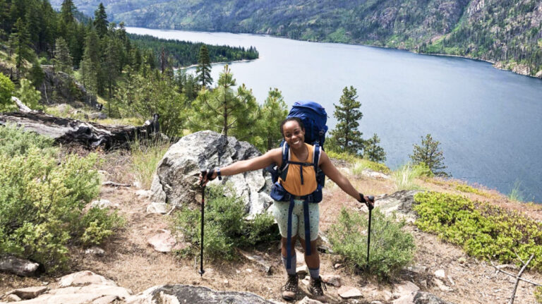 The author Chelsea Booker posing with scenic view of Lake Chelan