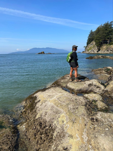 Author Chelsea standing on a rock at Bellingham’s Larrabee State Park