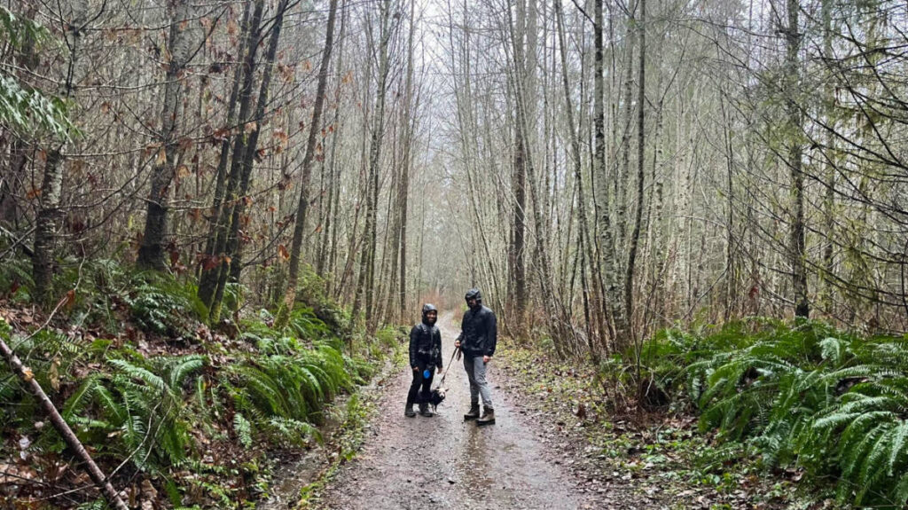 Author Chelsea with her husband and dog on a rainy hike in December