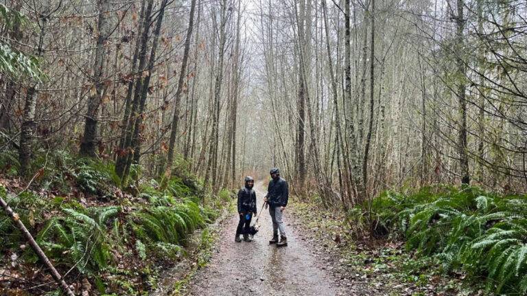 Author Chelsea with her husband and dog on a rainy hike in December