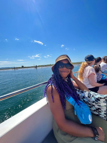 Author Chelsea riding a ferry to a secret beach