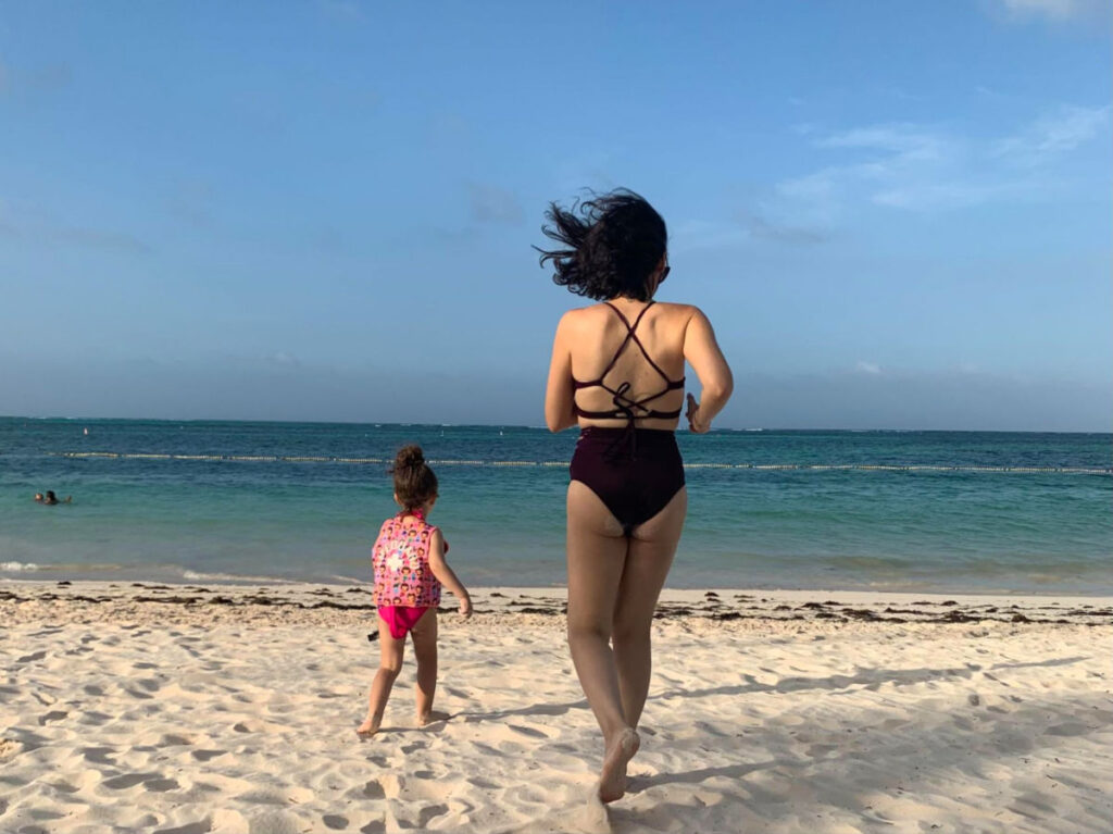 Author Claudicet and her daughter running towards the water in Playa Bibijagua