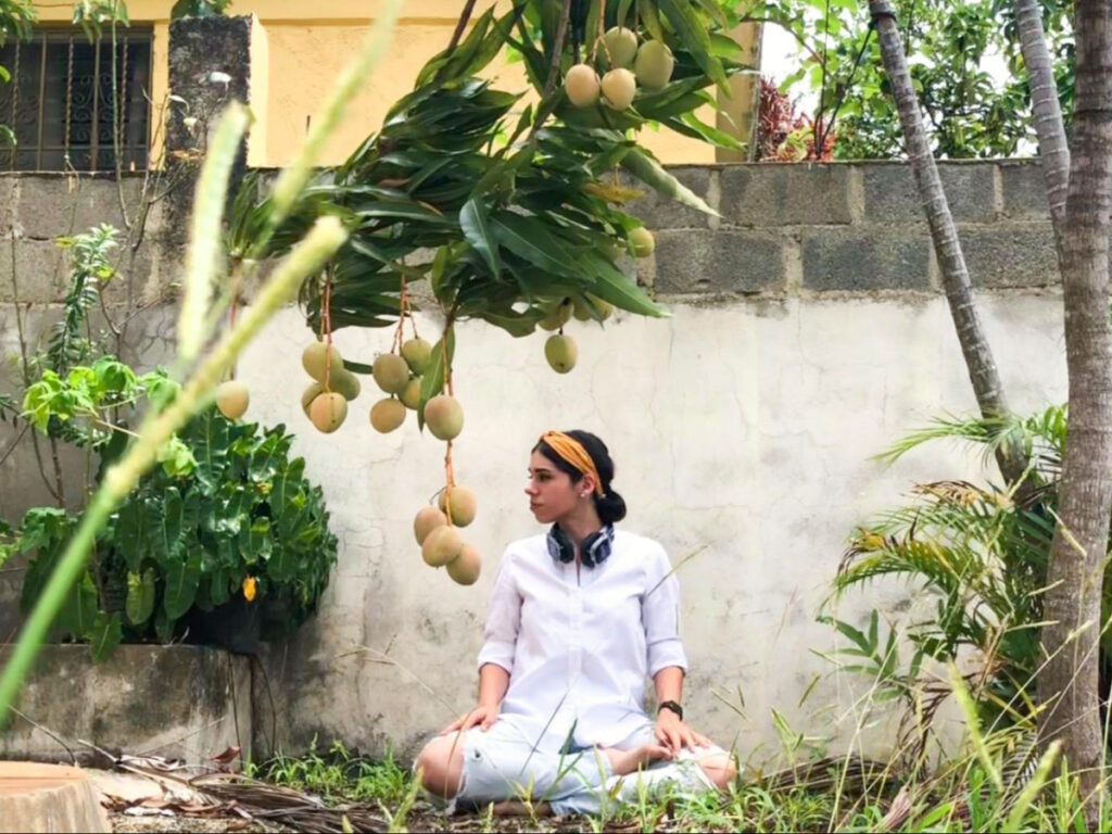 Author Claudicet meditating underneath a mango tree