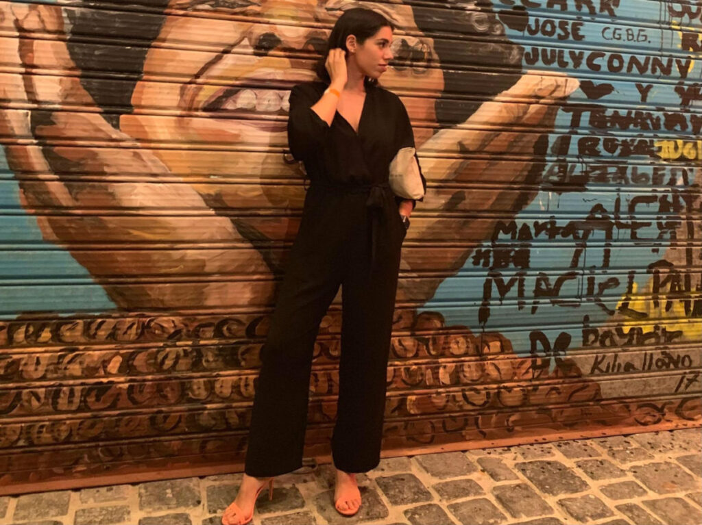 Author Claudicet posing for a photo at the art murals outside of SBG Punta Cana