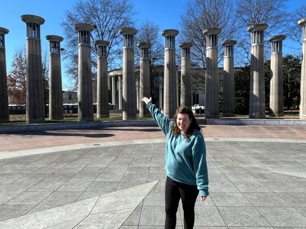 Author Elizabeth posing for a photo in front of the bell carillon