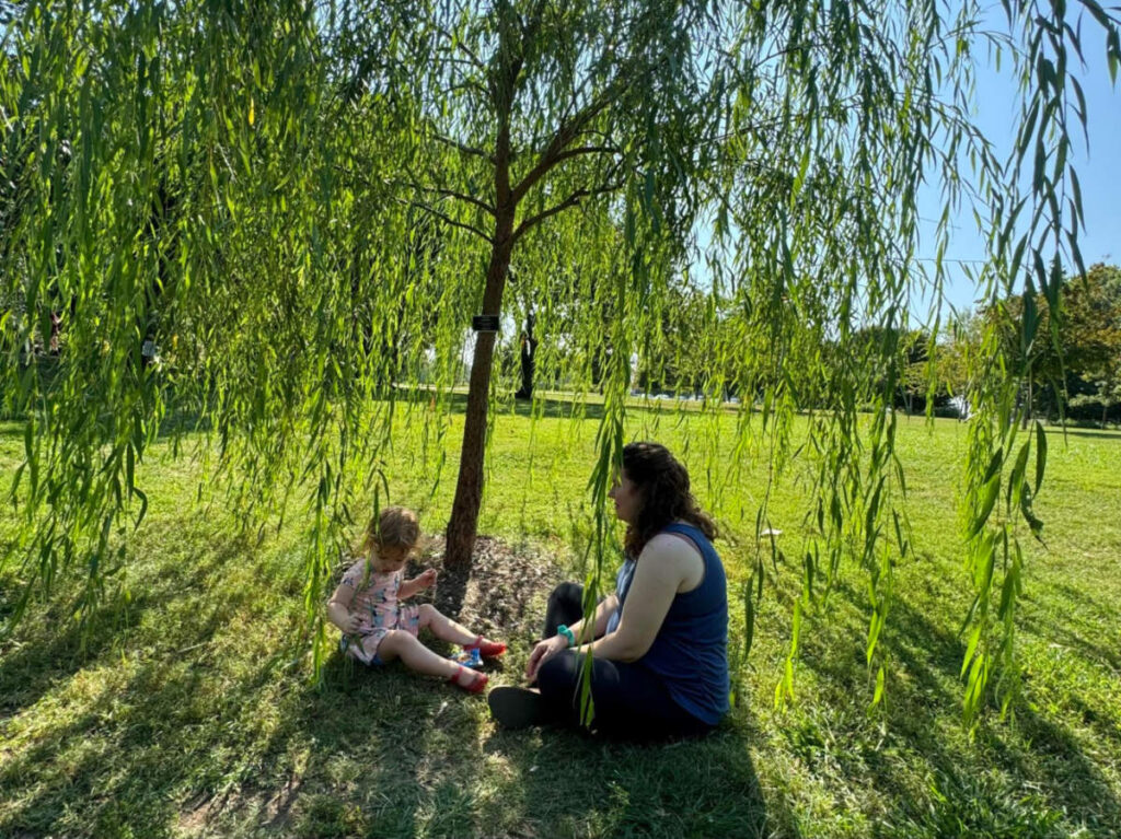 Author Elizabeth and her daughter playing underneath the willow tree