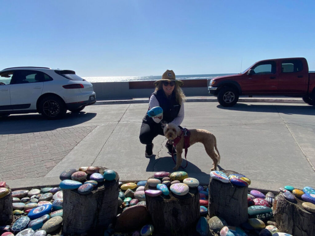 Author Jess placing a rock in the O’side Rock Garden