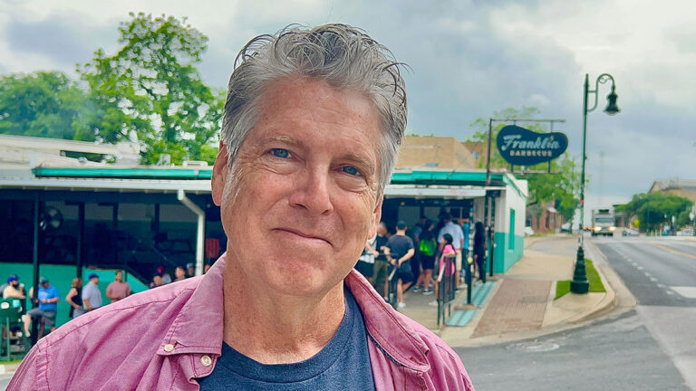 Author Kevin smiling while going to Franklin Barbecue