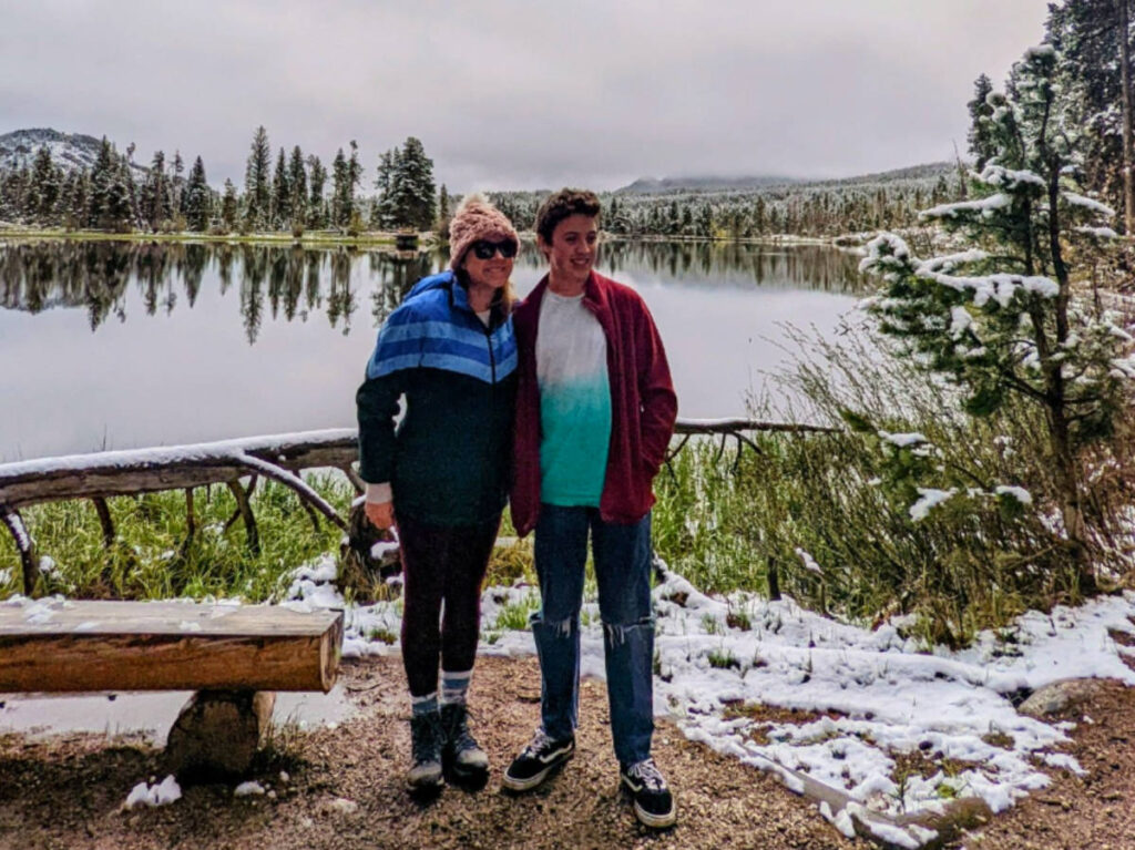 Author Laura and her son standing at Rocky Mountain National Park at the end of winter