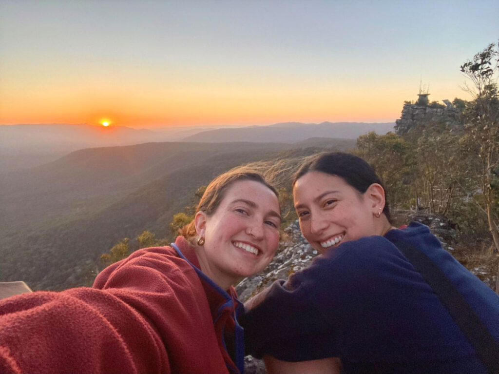 Author Laura and her friend taking a selfie with the sunset as their background at Grampians National Park