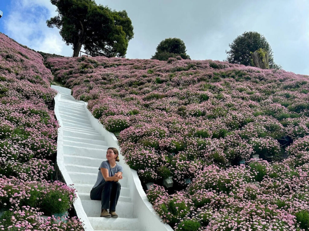 Author Laura sitting on the white stairs in Cameron Highlands Flora Park