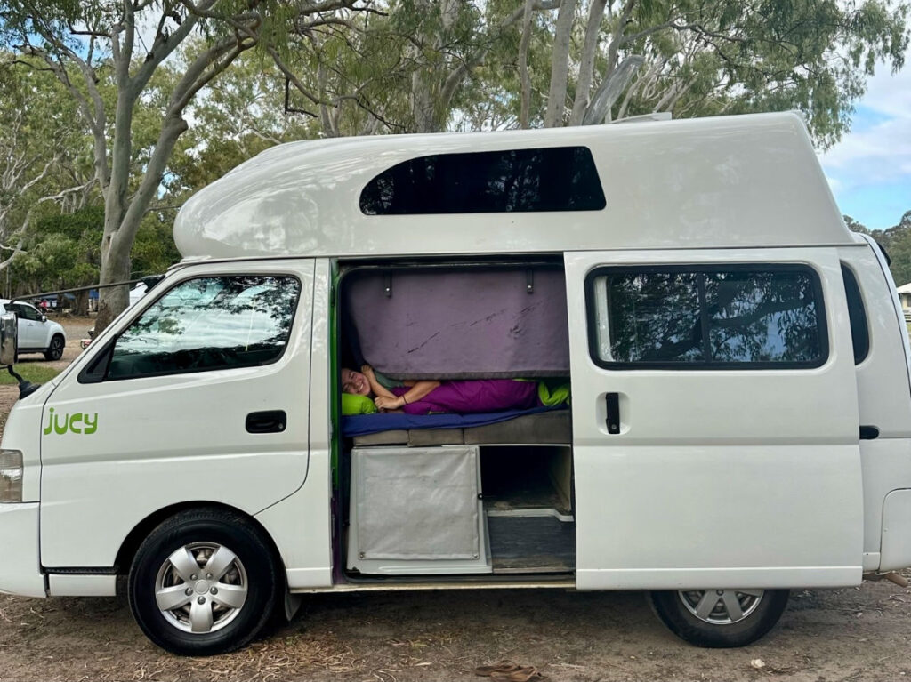 Author Laura happily sleeping on the campervan