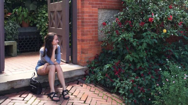Author Lea Rose Allbaugh admiring a plant in Asheville