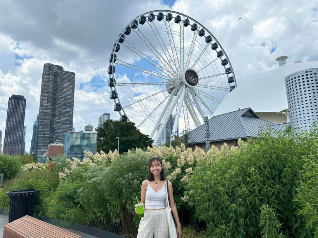 Travel Lemming author Lea Rose smiling brightly with the Navy Pier Centennial Wheel in her background