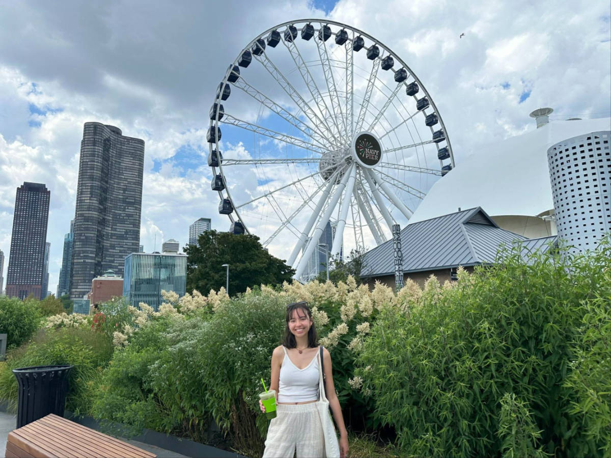 Travel Lemming author Lea Rose smiling brightly with the Navy Pier Centennial Wheel in her background