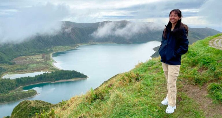 The author Lea Rose Allbaugh smiling for a photo on one of the viewpoint in São Miguel Island