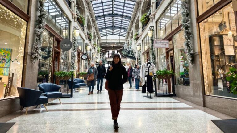 The author Lea Rose Allbaugh posing in the middle of Grove Arcade during Christmas