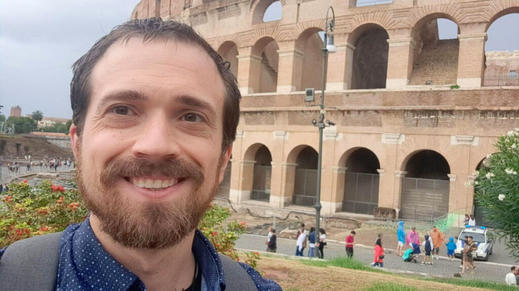 Author Matthew standing outside the Colosseum in Rome