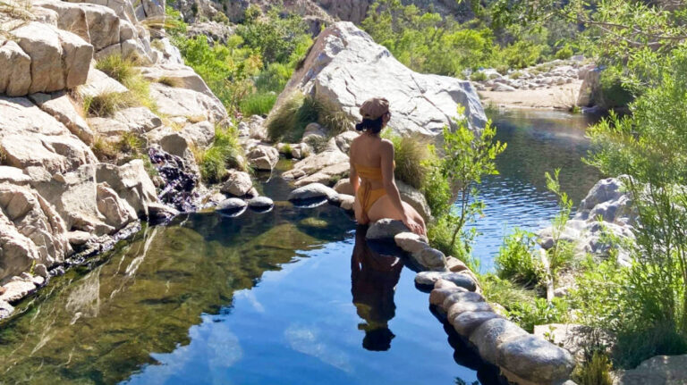The author McKenna Mobley, enjoying the view while sitting on the rock at the Deep Creek Hot Springs