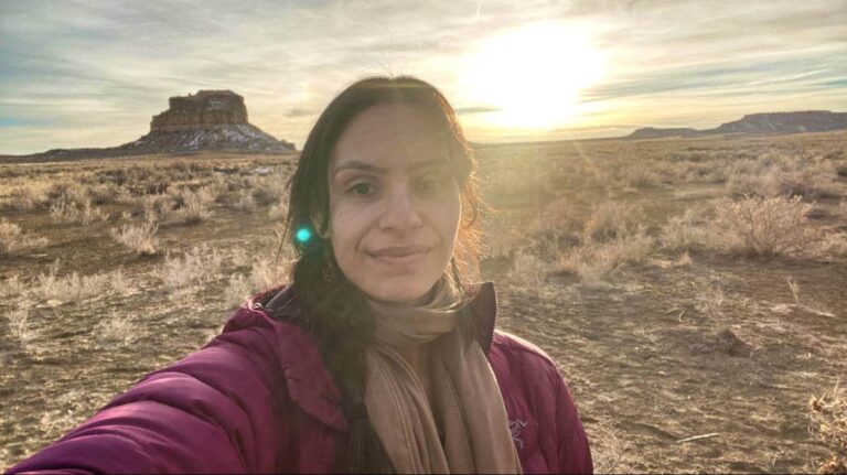 The author McKenna Mobley posing in front of a setting sun in Chaco Canyon National Historical Park