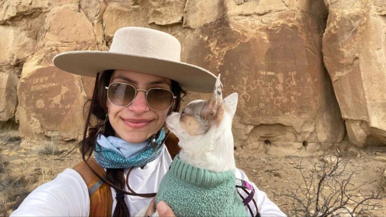The author McKenna Mobley carrying her dog in Chaco Canyon National Park