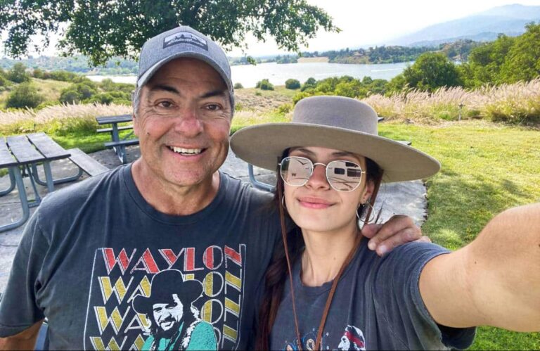 Author McKenna Mobley, posing for a selfie with a man near the lake in California