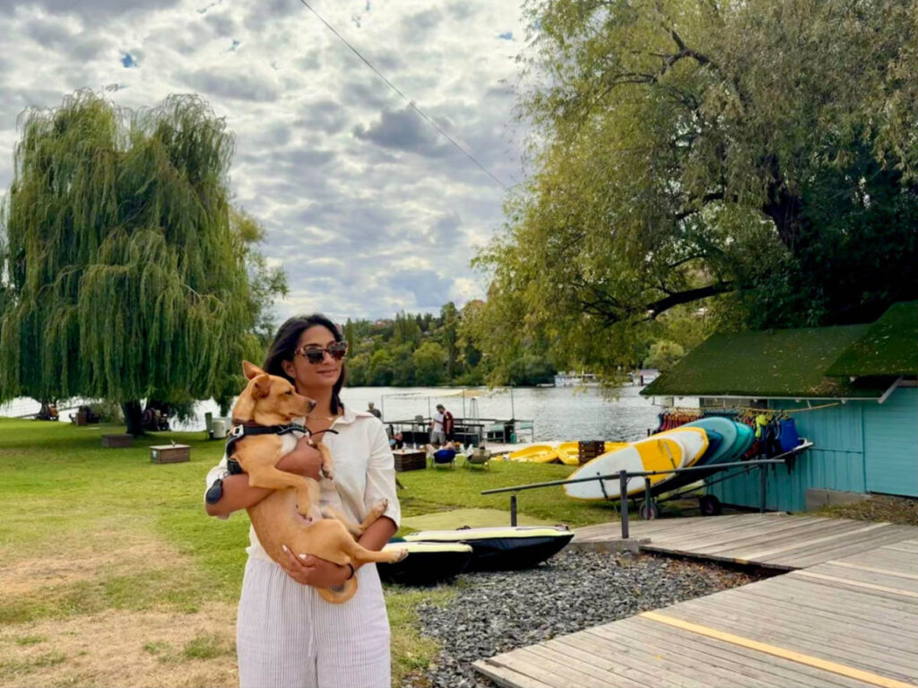 Author Meera holding her pet dog at Zlute Lazne