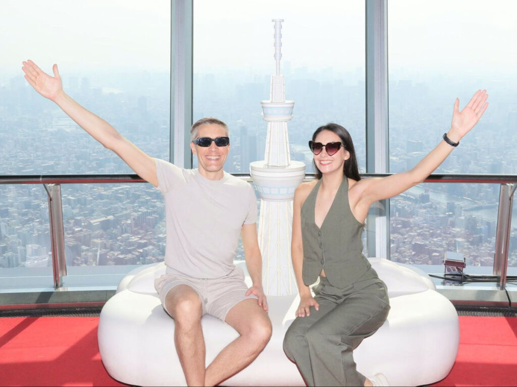 Author Nate and Clara posing for a photo at the top of the Tokyo Skytree