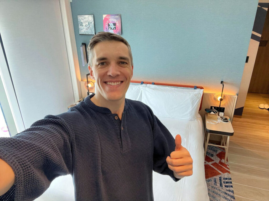 Author Nate wearing the pajama provided by Hotel Indigo