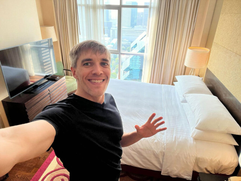 Author Nate showing the bedroom at the apartment