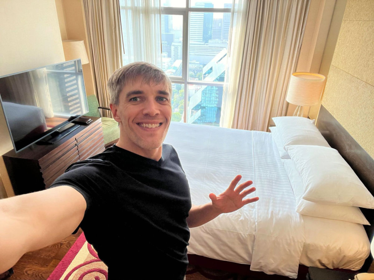 Author Nate showing the bedroom at the apartment