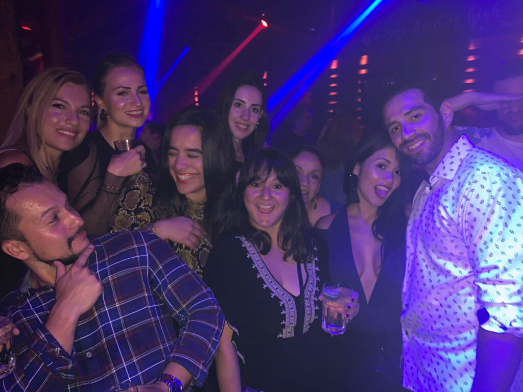 Author Niamh with friends smiling and posing together at a bar