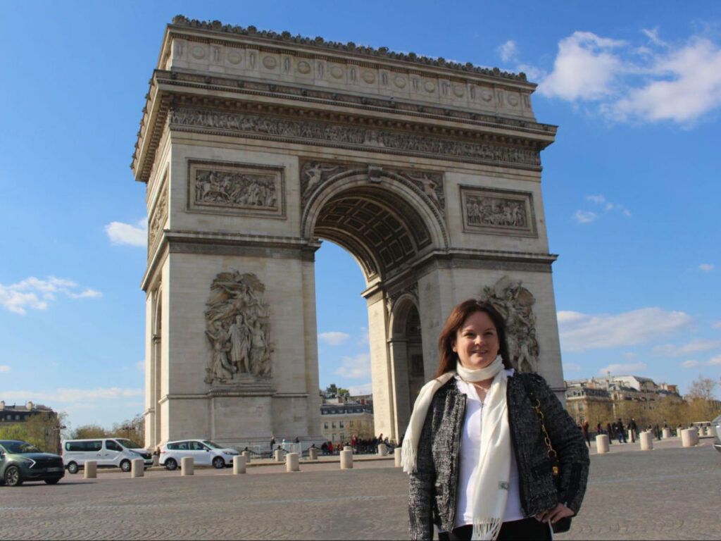 Author Rachel in front of The Arc de Triomphe