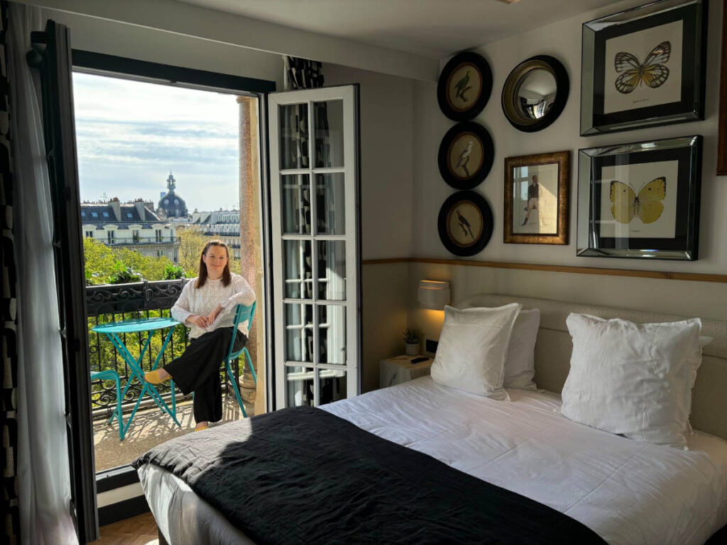 Author Rachel sitting on the balcony at a room of Solly Hôtel