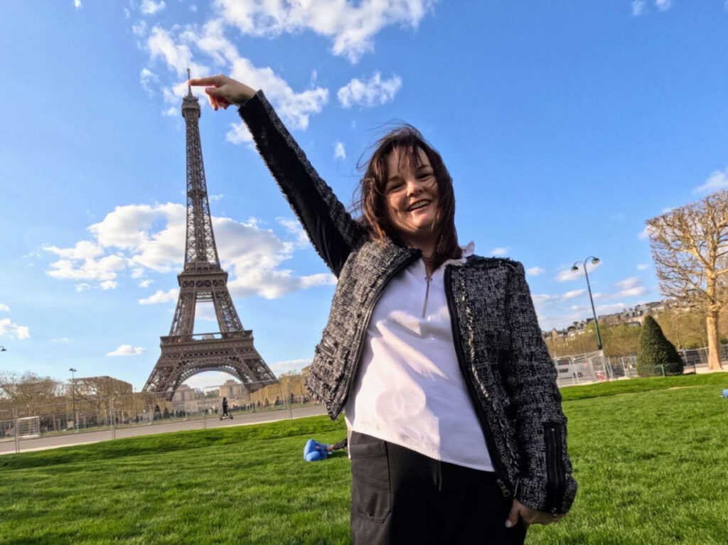 Author Rachel pointing at the tip of Eiffel Tower