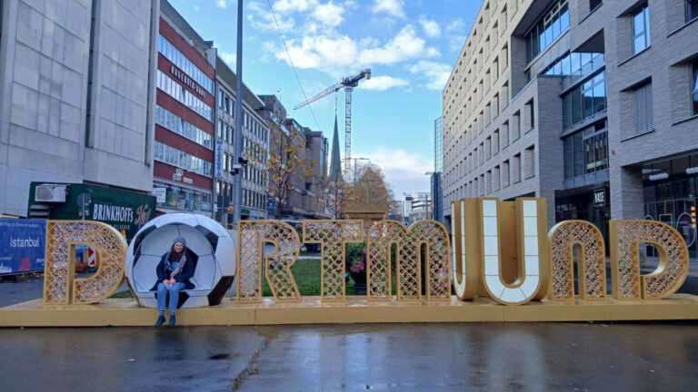 Author Ruthie sitting in the Dortmund sign