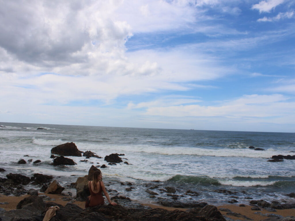 Author Sky sitting on a rock at a beach in Foz do Douro