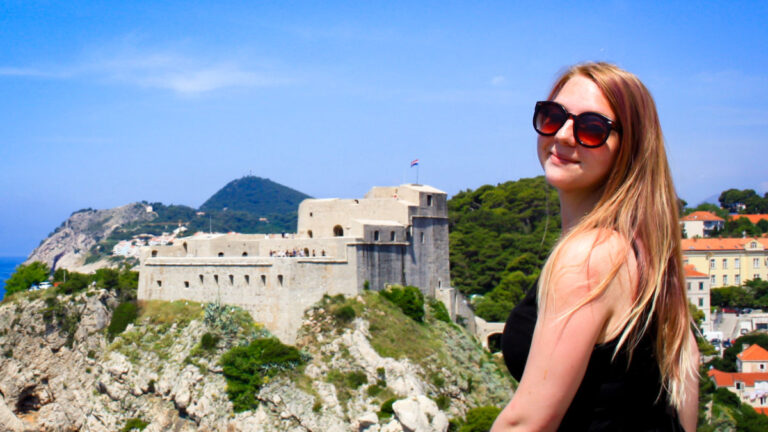 Author Taylor posing for a photo with the Fort Lovrijenac in the background