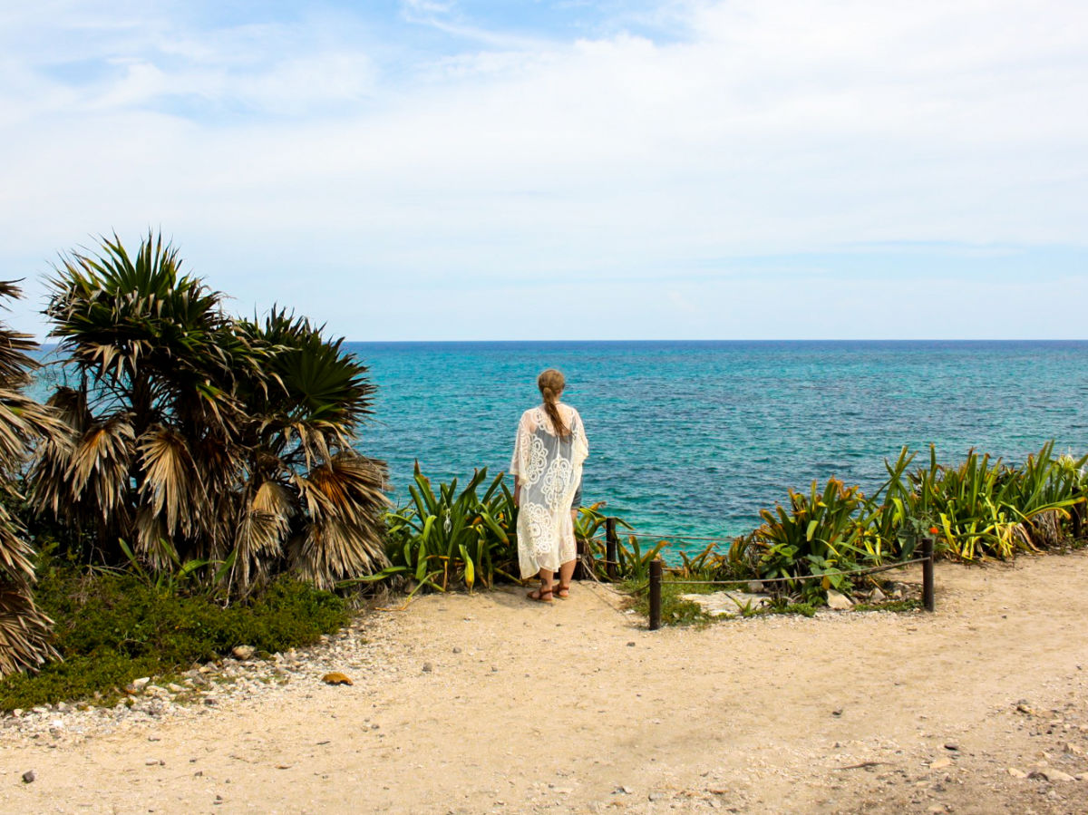 The author Taylor Herperger, enjoying the overlooking view of the ocean from the Tulum Ruins