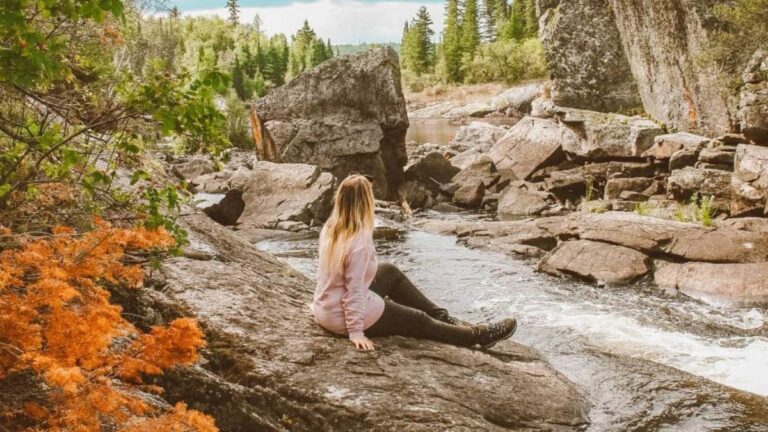 The author Taylor Herperger, sitting on a rock at Tulabi Falls